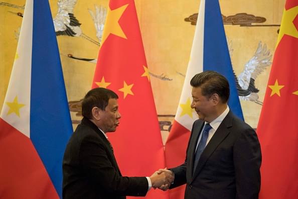 Rodrigo Duterte, left and Chinese President Xi Jinping shake hands after a signing ceremony on 20 October 2016 in Beijing, China. (Ng Han Guan-Pool/GettyImages)