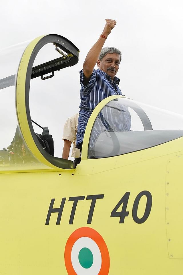 
Indian Defense Minister Manohar Parrikar poses for a photograph 
from the cockpit of a Hindustan Turbo Trainer-40 (HTT-40) aircraft 
developed by Hindustan Aeronautics Limited. (MANJUNATH KIRAN/AFP/Getty Images)

