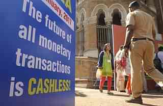Visitors walk past a sign for a digital or cashless economy at a Digital Wealth Fair promoting e-payments in Mumbai on 3 January  2017. (INDRANIL MUKHERJEE/AFP/GettyImages)