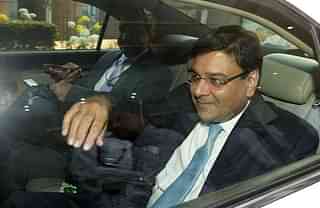 

RBI Governor Urjit Patel gestures as he sits in a vehicle after a meeting with West Bengal Chief Minister Mamata Banerjee in Kolkata. (DIBYANGSHU SARKAR/AFP/GettyImages)