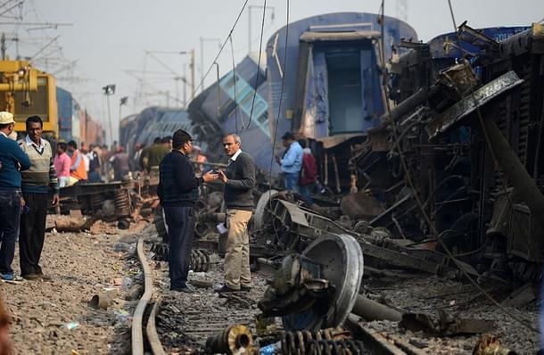 Indian officials gather at the wreckage of train carriages at
Rura. (SANJAY
KANOJIA/AFP/Getty Images)