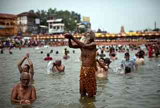 Hindu devotees bathe during the second ‘Shahi Snan’ (grand bath) of Kumbh Mela in the Godavari river, 2015, in Nashik. (Allison Joyce/Getty Images)