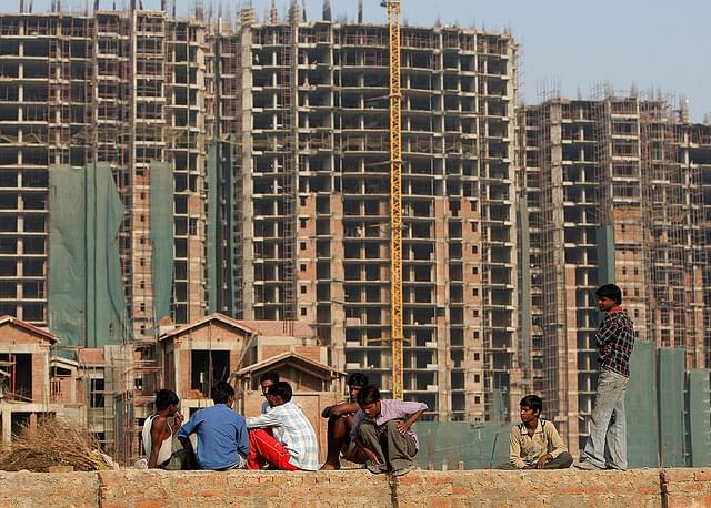  Indian construction workers rest at an under-construction site in Gurgaon, some 30 km south of New Delhi. (MANAN VATSYAYANA/AFP/Getty Images)
