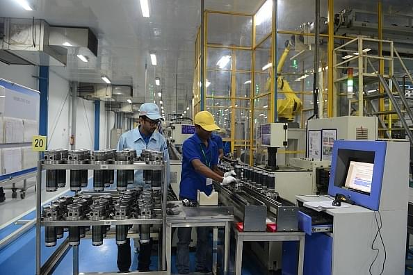 Workers at an assembly line of air-conditioner compressor plant at Matoda, near Ahmedabad. (SAM PANTHAKY/AFP/Getty
Images)