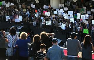 Protesters hold signs during a demonstration against the immigration ban that was imposed by US President Donald Trump at Los Angeles International Airport on 29 January 2017 in Los Angeles, California. (Justin Sullivan/Getty Images)