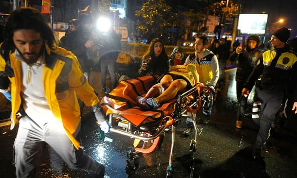 First-aid officers carry an injured woman at the site of the armed attack in Istanbul. (GettyImages)