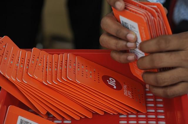 A staff member arranges Reliance Jio Infocomm 4G mobile service SIM cards at a store in Mumbai. (INDRANIL MUKHERJEE/AFP/Getty Images)