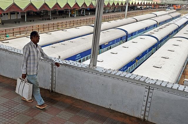 A commuter uses an overhead bridge to get across platforms at the City Railway Station in Bengaluru. (Manjunath Kiran/AFP/Getty Images)