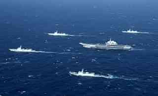 

A Chinese navy formation, including the aircraft carrier Liaoning (C), during military drills in the South China Sea. (STR/AFP/GettyImages)