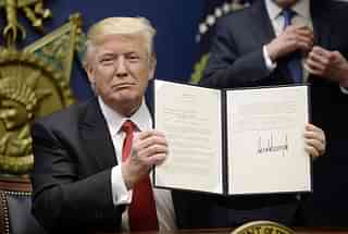 President Trump signs an executive
order. (Olivier
Douliery-Pool/GettyImages)<em></em>