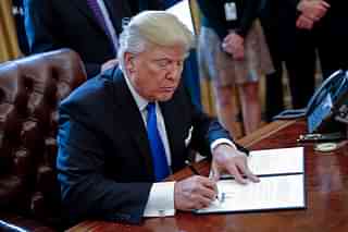 
US President Donald Trump signs an executive order related to the oil pipeline. (Shawn Thew-Pool/Getty Images)


