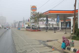 A woman sells petrol in front of the closed fuel station. One litre of petrol costs up to Rs 300. (Rajkumar Mixn)