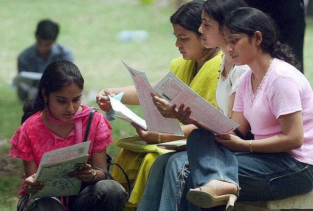  Indian students read admission forms at the Delhi University. (MANPREET ROMANA/AFP/Getty Images)