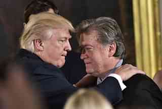 

US President Donald Trump  congratulates Senior Counselor to the President, Stephen Bannon during the swearing-in of senior staff. (MANDEL NGAN/AFP/GettyImages)