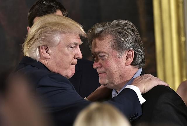 

US President Donald Trump  congratulates Senior Counselor to the President Stephen Bannon during the swearing-in of senior staff (MANDEL NGAN/AFP/Getty Images)