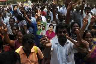 

Supporters of the AIADMK party celebrate in front of the residence of the acting chief minister O Panneerselvam  in Chennai. (ARUN SANKAR/AFP/GettyImages)