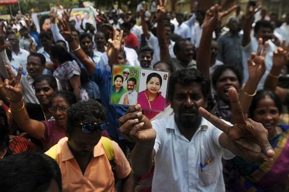 Supporters of the AIADMK party celebrate in front of the residence of the acting chief minister O Panneerselvam in Chennai. (ARUN SANKAR/AFP/GettyImages)