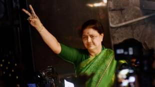 AIADMK general secretary V K Sasikala shows the victory sign as
she comes out to address media at Poes garden in Chennai. (PTI)