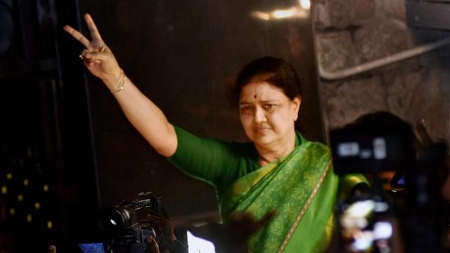 
							AIADMK general secretary V K Sasikala shows the victory sign as 
she comes out to address media at Poes Garden in Chennai. (PTI)


