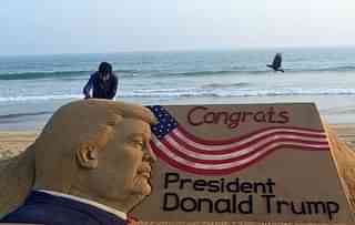 

Indian sand artist Sudarsan Pattnaik gives the final touches to his sand sculpture of  Donald Trump at Puri beach, some 65 kilometers away from Bhubaneswar on 19 January  2017. (STRINGER/AFP/Getty Images)
