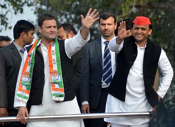 Rahul Gandhi (left) and Akhilesh Yadav wave to supporters during a joint roadshow through the streets of Lucknow. (STRINGER/AFP/Getty Images)