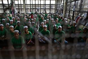 Illegal 
Rohingya 
immigrants 
gather at an Immigration Detention Centre.