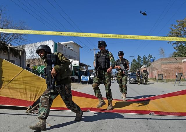 Pakistani soldiers arrive at the site of a court complex after multiple Taliban suicide bombings in the Tangi area of Charsadda district. (ABDUL MAJEED/AFP/Getty Images)