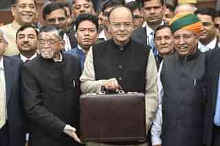 Finance Minister Arun Jaitley (centre) leaves his office to table the budget in Parliament in New Delhi last year. (DOMINIQUE FAGET/AFP/GettyImages)