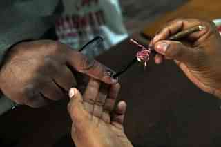 An Indian election officer marks the finger of a voter at a polling station. (PRAKASH SINGH/AFP/Getty Images) 