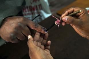 An Indian election officer marks the finger of a voter at a polling station. (PRAKASH SINGH/AFP/Getty Images)