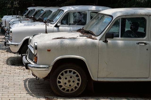 

Defunct Ambassador cars of the state government gather dust at a parking lot in Bengaluru.(MANJUNATH KIRAN/AFP/GettyImages)