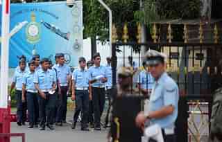 Indian Airforce cadets walk past as security personnel stand outside Tambaram Air Force Station in Chennai. (ARUN SANKAR/AFP/Getty Images)