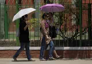 Women walk along a street in New Delhi. (MANPREET ROMANA/AFP/Getty Images)