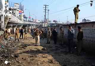 Indian police look on at the site of a bomb blast in Dimapur, Nagaland, ahead of the Nagaland Assembly polls. (Caisii Mao/AFP/Getty Images)
