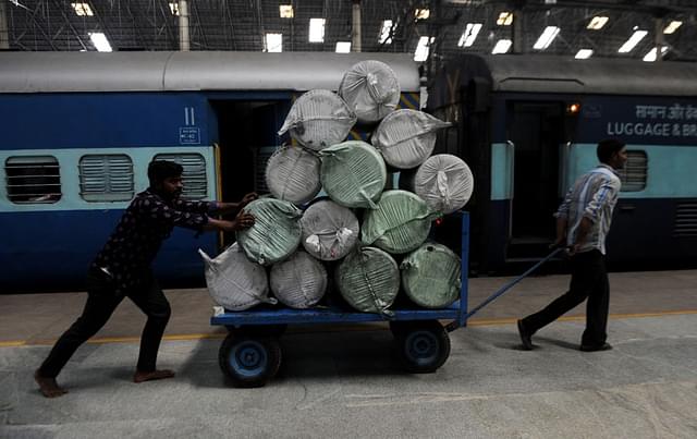 Indian railways workers use a cart to transport goods through a train station in Chennai. (ARUN SANKAR/AFP/Getty Images)