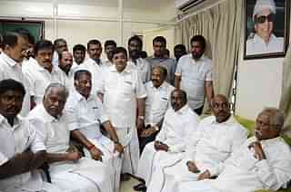 O Paneerselvam (seated third from left) is surrounded by supporters during a press conference at his home in Chennai. (STRINGER/AFP/GettyImages)