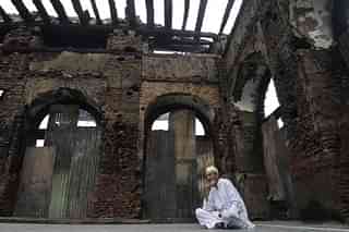 

A Kashmiri Muslim sits next to the ruins of a revered 200-year old sufi shrine in Srinagar. (TAUSEEF MUSTAFA/AFP/GettyImages)
