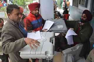 Poll officials carry Electronic Voting Machines. (Representative Image) (NARINDER NANU/AFP/Getty Images)