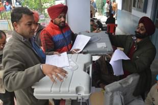 Poll officials carry Electronic Voting Machines in Amritsar. (NARINDER NANU/AFP/Getty Images)