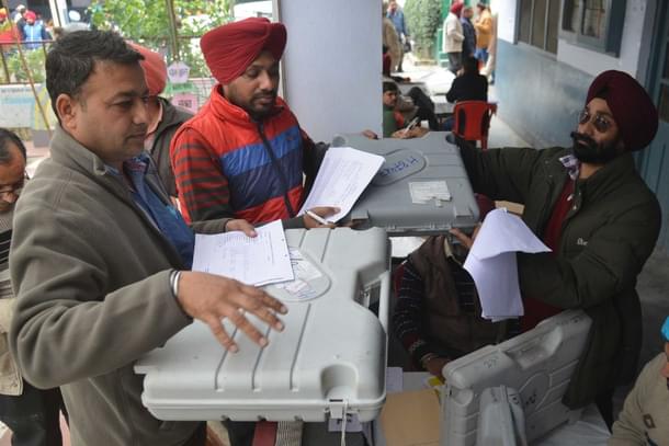 Poll officials carry Electronic Voting Machines in Amritsar. (NARINDER NANU/AFP/Getty Images)