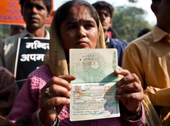 A Hindu refugee from Pakistan shows her now-expired Indian visa page on her passport during a demonstration. (Representative Image)(PRAKASH SINGH/AFP/Getty Images)