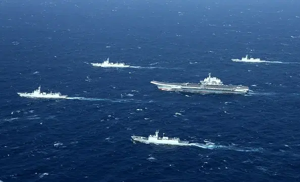 A Chinese navy formation, including the aircraft carrier Liaoning (centre), during military drills in the South China Sea. (STR/AFP/Getty Images)