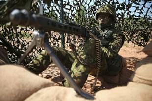 An Estonian soldier mans a machine gun prior to an aircraft attack demonstration during the NATO ‘Spring Storm’ military exercises. (Sean Gallup/Getty Images)