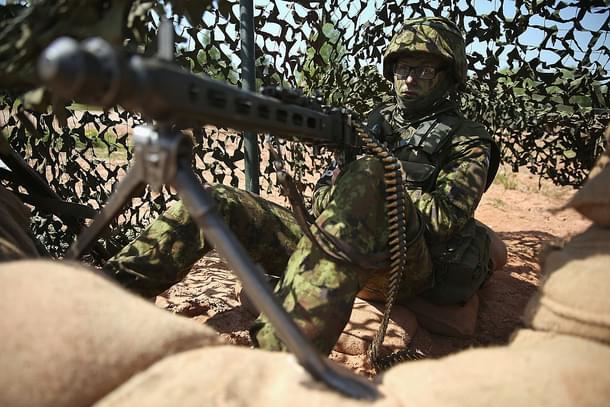 An Estonian soldier mans a machine gun prior to an aircraft attack demonstration during the NATO ‘Spring Storm’ military exercises. (Sean Gallup/Getty Images)