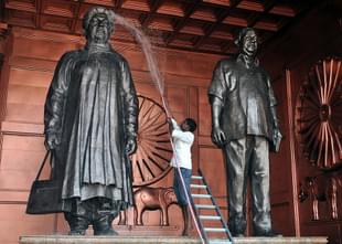 An Indian labourer washes a statue of the Chief Minister  Mayawati. (STRDEL/AFP/Getty Images)