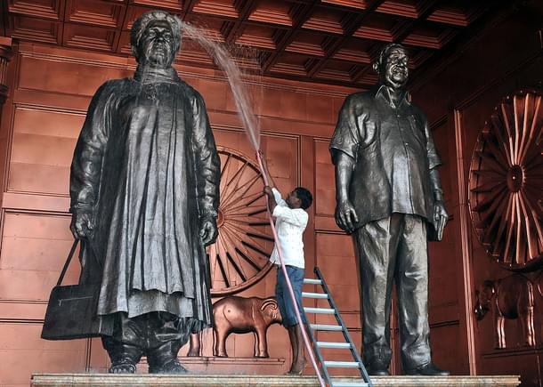An Indian labourer washes a statue of the Chief Minister  Mayawati. (STRDEL/AFP/Getty Images)
