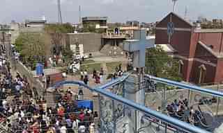 Citizens gather in front of a church following suicide bombing attacks on churches in Lahore. (Dawn)

