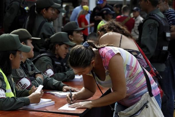 A Venezuelan woman at customs, before crossing over the Simon Bolivar international bridge into Colombia. <a href="http://pictures.reuters.com/Doc/RTR/Media/TR3/2/d/0/e/RTX2KKON.jpg">Eduardo Ramirez/Reuters</a>