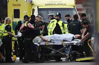 A member of the public is treated by emergency services near Westminster Bridge and the Houses of Parliament after the terror attack. (Carl Court/GettyImages) &nbsp;