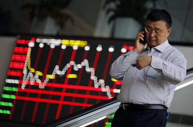
A man is seen inside the Shanghai Stock Exchange in Changhai’s Pudong financial district. (REUTERS)